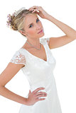 Woman in wedding dress posing over white background