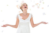 Happy bride being showered with petals
