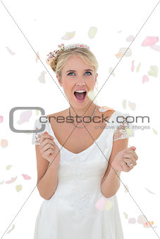 Surprised bride being showered with petals
