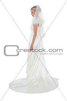Woman in luxurious wedding dress over white background