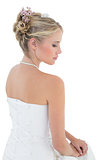 Bride in off shoulder dress against white background