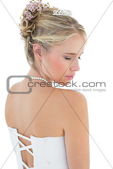 Rear view of shy bride in off shoulder dress