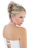 Rear view of thoughtful bride in off shoulder dress