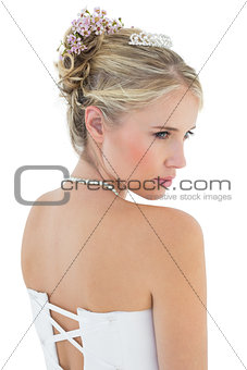 Rear view of thoughtful bride in off shoulder dress