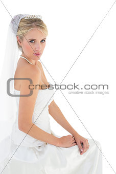 Sensuous bride in off shoulder dress against white background
