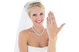 Happy bride showing wedding ring over white background