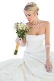 Bride with eyes closed smelling flower bouquet