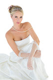 Sensuous bride sitting against white white background
