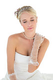Bride with eyes closed touching shoulder