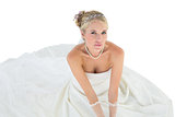 Portrait of elegant bride sitting over white background
