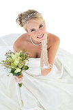 Portrait of smiling bride holding flower bouquet