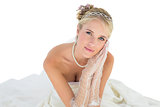 Bride with hands clasped over white background