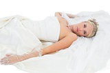Sensuous bride lying over white background