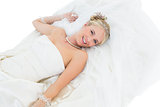 Happy bride lying over white background