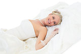 Elegant bride lying over white background