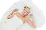 Smiling bride lying over white background