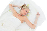 Bride lying while contemplating over white background