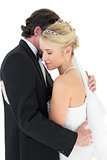 Affectionate bride and groom embracing