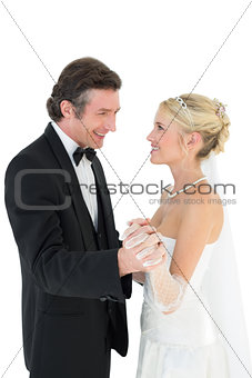 Newly wed couple holding hands while dancing