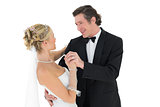Bride and groom dancing over white background
