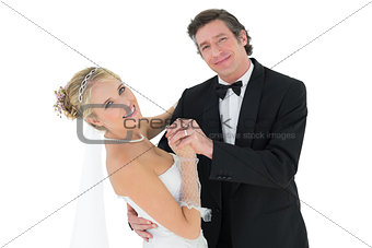 Happy couple dancing over white background