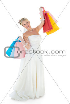 Bride carrying shopping bags over white background