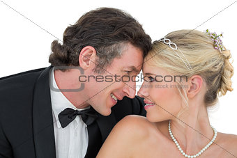 Smiling bride and groom with head to head