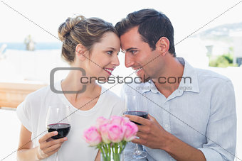Couple with wine glasses looking at each other