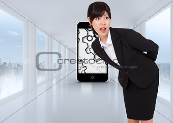 Composite image of surprised businesswoman bending