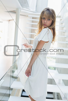 Portrait of a young woman standing on stairs