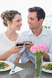 Loving couple with wine glasses looking at each other