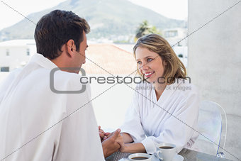 Loving couple holding hands at home