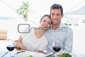 Loving couple with wine glasses at lunch table