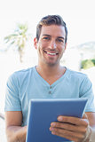 Portrait of a smiling man using digital tablet