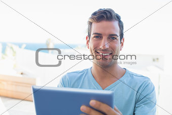 Portrait of a smiling man using digital tablet
