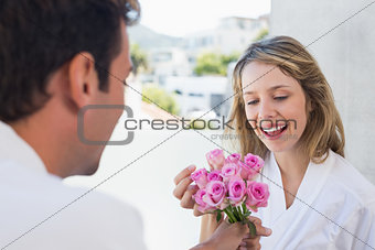 Man giving happy woman flowers