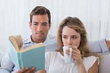 Couple reading book on couch