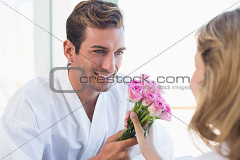 Close-up of a man giving woman flowers