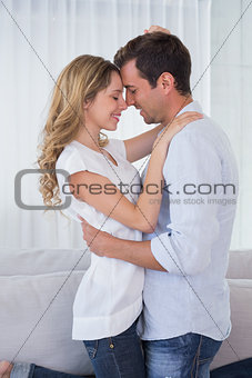 Loving young couple with eyes closed