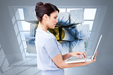 Composite image of confident businesswoman using a laptop