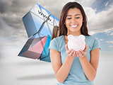Composite image of attractive woman posing with a piggy bank