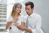 Woman showing engagement ring to man