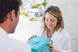 Man giving happy woman a gift box