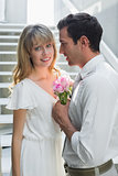 Loving young couple with flowers at home