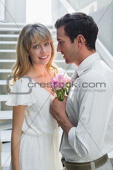 Loving young couple with flowers at home