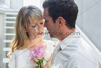 Close-up of a loving couple with flowers