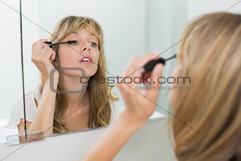 Close-up of a beautiful woman applying mascara