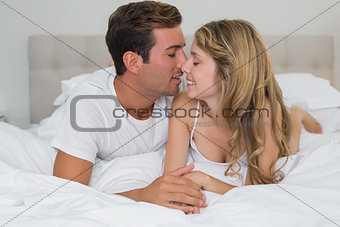 Close-up of a loving couple lying in bed