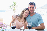 Loving couple with wine glasses at dining table