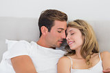Close-up portrait of a relaxed couple in bed